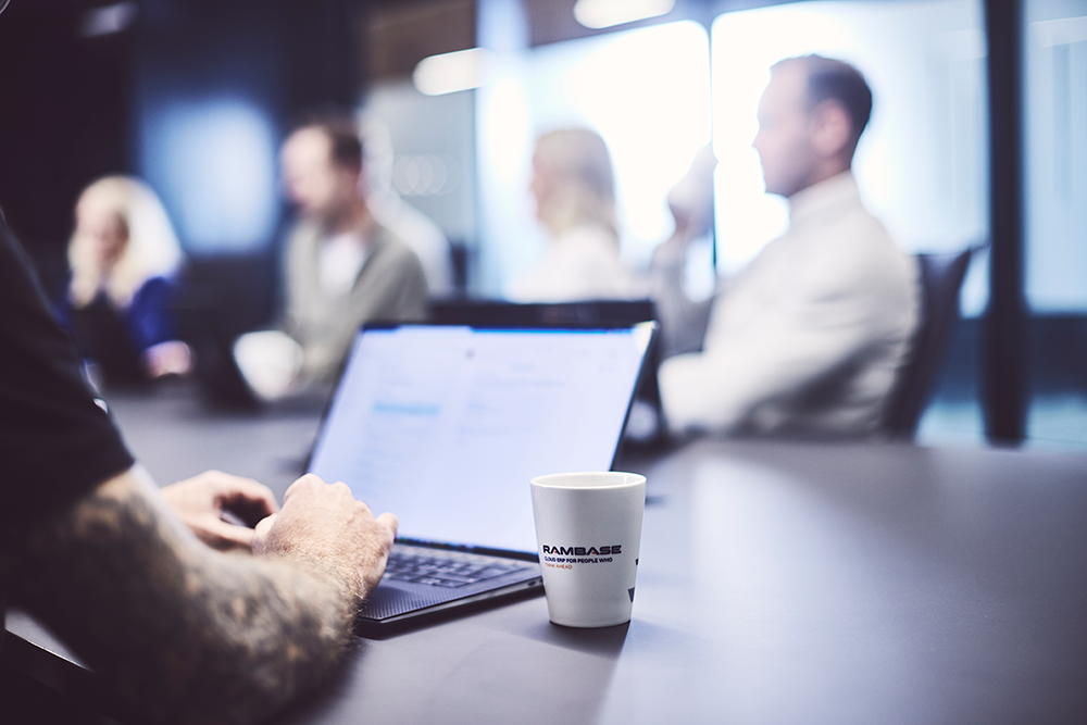 person and pc in a meeting room